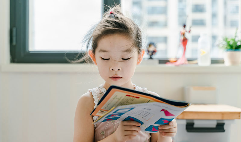 A girl reading an interesting magazine