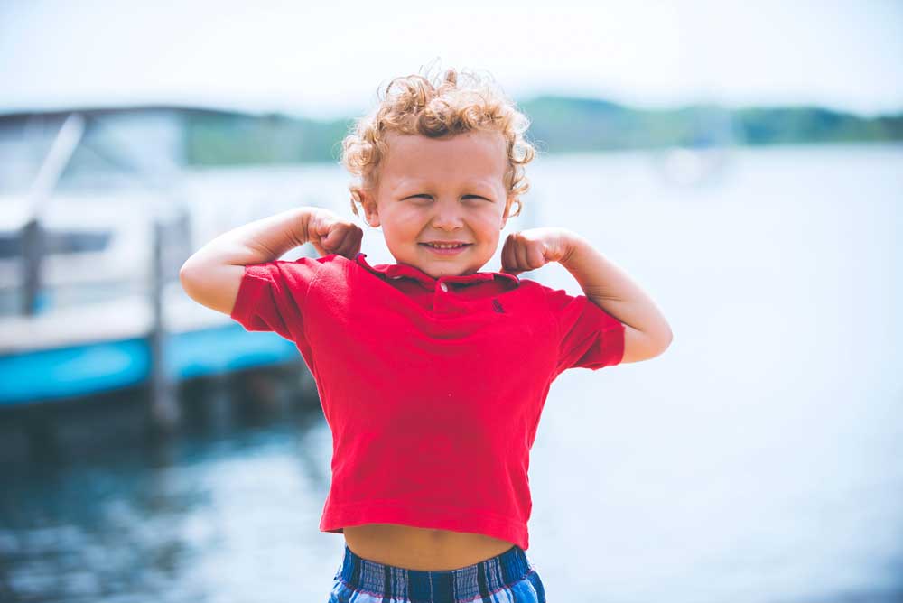 A happy young boy looking strong and healthy.